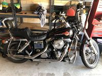 Full left-side view of motorcycle parked in garage