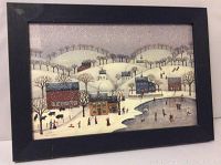 Framed print showing winter village scene with people skating and sledding, under glass in blue painted wooden frame