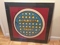 Framed print of New York sewer cover with 'NEW YORK SEWER' text, visible black frame and glass