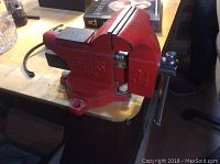 Front side view of Sears 5175 3.5-inch red bench vise mounted on a workbench, showing the jaws, handle and overall condition.