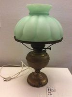 Full view of lamp complete with green milk glass shade and brass base, showing overall condition and size.