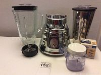 Complete set photographed on table with all parts: glass pitcher with lid, stainless steel milkshake pitcher, motor base, plastic mini jar and boxed blade.