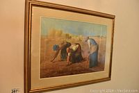 Gold-framed print of The Gleaners by Jean Francois Millet with matting and glass protecting the print.