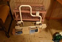 Lot includes pink plastic shoe racks, white Safety First grab bar, and boxed chrome grab bar with fridge movers.