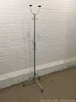 Full view of the retro chrome coat and hat stand showing tripod base and multiple hooks.