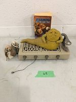 Full shot of Jabba the Hutt figure reclining on ornate beige platform, three additional character figures in robes standing nearby, and paperback book behind them.