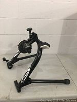 Side angled view showing black metal frame, magnetic resistance unit, and adjustment knob.