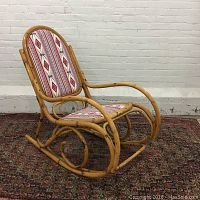 Side view of a bamboo cane bentwood rocking chair with southwestern patterned reupholstered seat and back, showing curved armrests and rockers.
