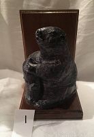 Front view of hand-carved soapstone beaver sculpture mounted on wooden plaque with felt backing.
