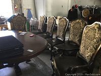 Six chairs arranged around table in warehouse setting