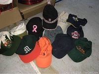 Table display of assorted baseball caps and visors in different colors and embroidered logos