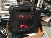 Black insulated cooler bag with red embroidered text 'APPETIZERS' and Sysco logo on front pocket, box with other bags visible below.