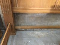 Close-up of one side of the solid oak king size bed frame showing the fluted column design on the post and part of the footboard and side rail.
