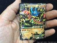 Front view showing holo foil Mega Lucario EX Pokemon card with 220 HP, visible wear on card edges and slight surface wear.
