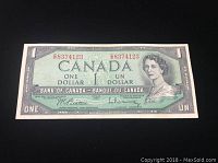 Front of 1954 Canadian one dollar banknote with serial number and portrait of Queen Elizabeth II