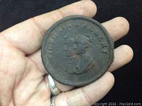 Front view showing the raised profile of Victoria and Albert on the iron bottle cap lid with surrounding inscription.