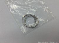 Pair of small round sterling silver hoop earrings in a clear plastic bag on a white background.