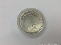 Front side of the 1980 Northern Ontario $1 coin with map design in protective capsule.