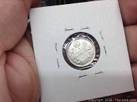 Reverse of the coin shows the denomination 5 cents within a crowned wreath with clear date 1907.