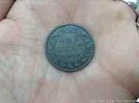 Reverse side of 1859 Canadian Large Cent Victoria coin showing denomination and date with wreath