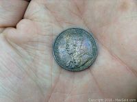 Obverse of 1912 Canadian one cent coin showing King George V and rainbow toning on coin surface.