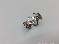 Photo showing the silver ring with an abstract open loop design.