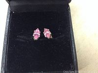 Pair of pink topaz marquise cut stud earrings set in .925 sterling silver, presented in black jewelry box.