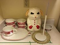 Photo of three Premium Plus soup bowls and one lamb chop cookie jar with other kitchen items on counter.