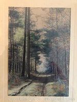 Full view of the hand tinted vintage photograph showing a tree-lined dirt road, mounted with visible water damage to the bottom of the mat but not on the image.