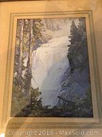 Framed vintage print showing waterfall, trees and cliffs in a natural landscape.