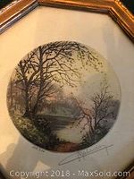 Photo of the front circular aquatint image with Parisian landscape in a gold hexagonal frame.