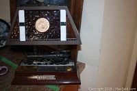 Front angle of Lionel train lamp showing detailed black locomotive and LIONEL base with clock medallion on trapezoidal plastic shade.