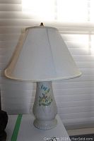 Full view of one lamp with white fabric lampshade, showing the 20inch height and classic shape