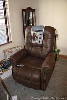 Front view of brown power lift recliner in dining room setting