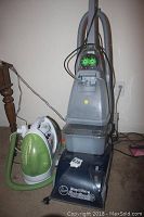 Hoover SpinScrub SteamVac upright carpet cleaner with Bissell Little Green behind it, placed on carpet floor