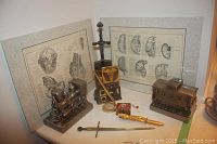 Full lot with bookends, anatomical prints, letter openers on table against white background
