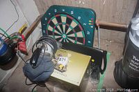 Electronic dart board, Gold Label Christmas Cannonball box, and vintage Royal hand vacuum cleaner with cord visible
