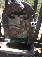 Front view of the angel motif decorative fountain showing mosaic tile work and basin.