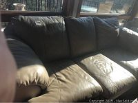 Front view showing full seat cushions, back cushions, and padded arms