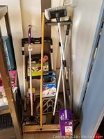 Photo showing the utility cart, step ladder, broom, Swiffer mop, and two cleaning wands grouped together