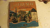 Living French language course box with illustrated Parisian scene and text indicating 40 lessons on records.