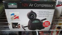 Box of Meridian Point 12V air compressor with nozzle adaptors