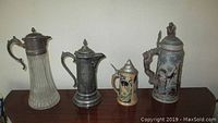 Photo showing all four steins in the set, highlighting size and variety.