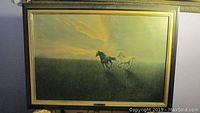 Framed horse print showing two horses running in a field with sunset or sunrise background.