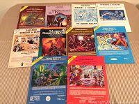 Top-down view of all 10 Dungeons & Dragons modules arranged side-by-side on a table showing the variety of cover arts and titles included in the lot.