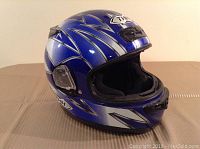 Front-angle view of blue full-face snowmobile helmet with white and silver design, padded interior, and ventilation controls, no visor.