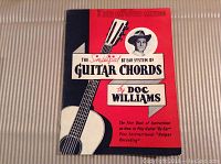Front cover of the 1959 Doc Williams Simplified Guitar Chords Book A showing title, author, and artwork of guitar and portrait of Doc Williams.