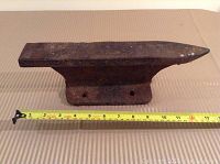 Side view of steel anvil with measuring tape showing length approximately 13 inches