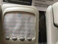 Close-up of one General Electric corded phone LCD and button panel in white, showing numeric keypad and speed dial buttons.