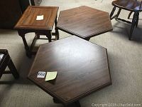 Three wooden side tables: Two matching hexagonal shape tables and one smaller rectangular table, all brown wood finish.